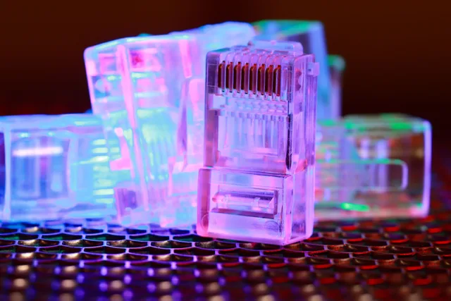 Vibrant close-up of network cable connectors with colorful lighting. What actually changes about leaving a decentralized network?