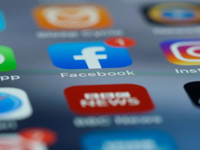 Close-up of smartphone screen displaying various social media app icons including Facebook. How Long Does It Take to Delete a Social Media Account Permanently?
