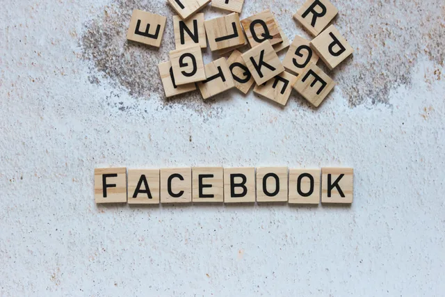 Wooden Scrabble tiles spelling Facebook on a textured surface. Ideal for social media concepts. Where to File a Social Media Platform Complaint in Canada