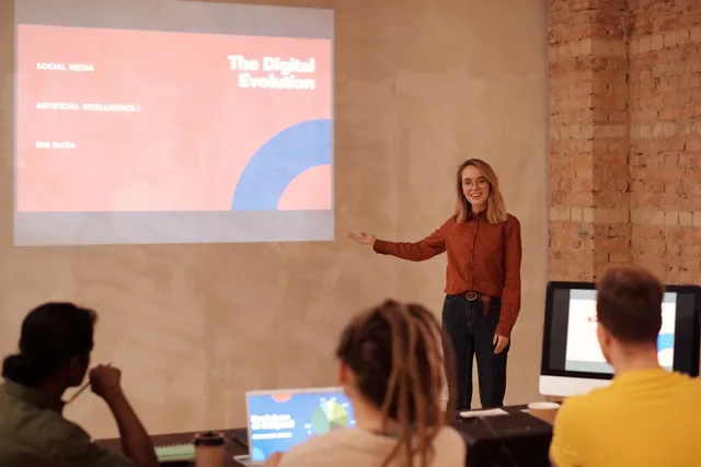 Young woman presenting on digital evolution concepts like AI and big data in a seminar. Major social networks facts: why user counts differ